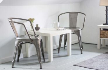 A table and two chairs in a room.