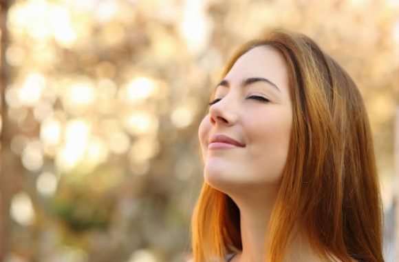A woman smiling while breathing